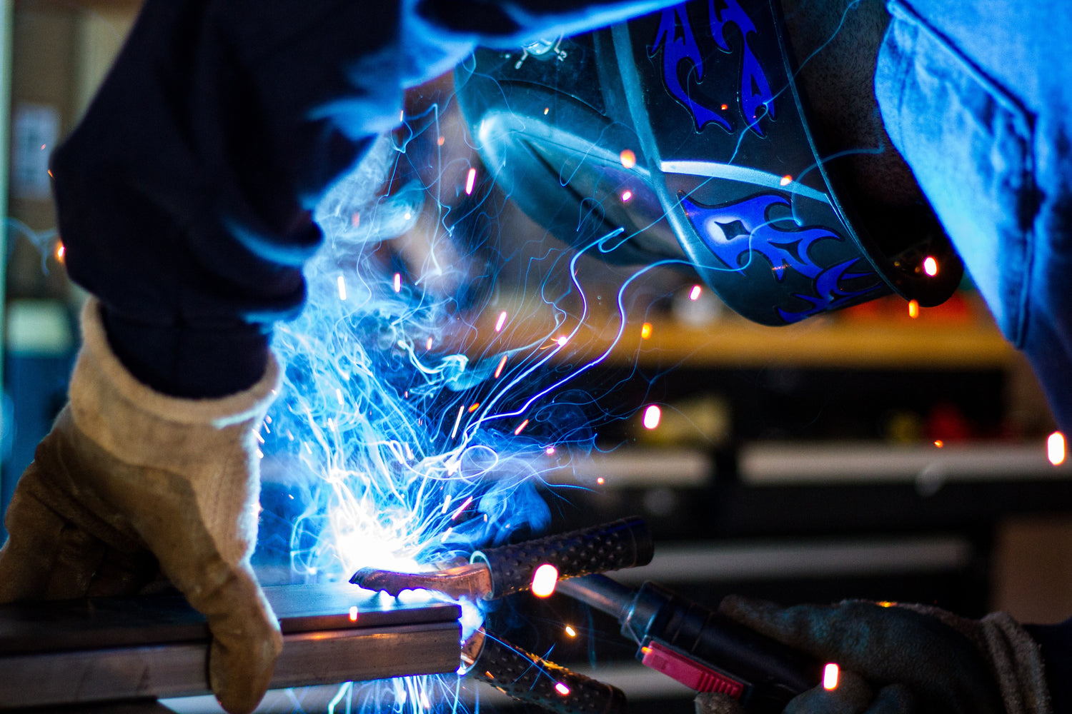 Welder Welding with Blue Sparks Flying