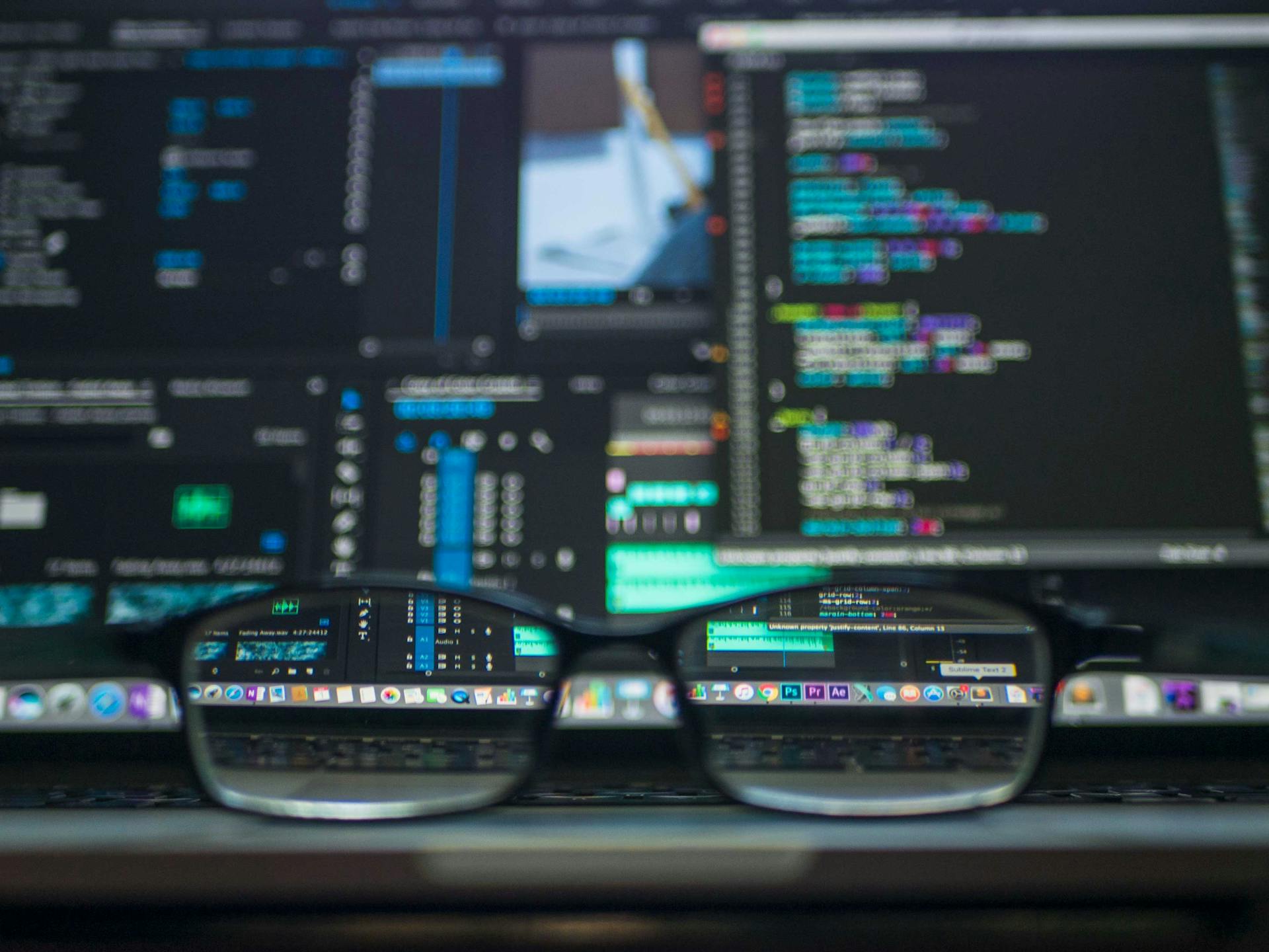 Computer Monitor With Eye Glasses in the Foreground